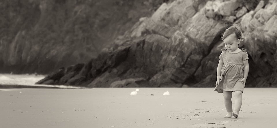 Baby walking on beach