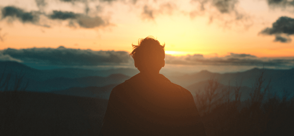 man looking at sunset