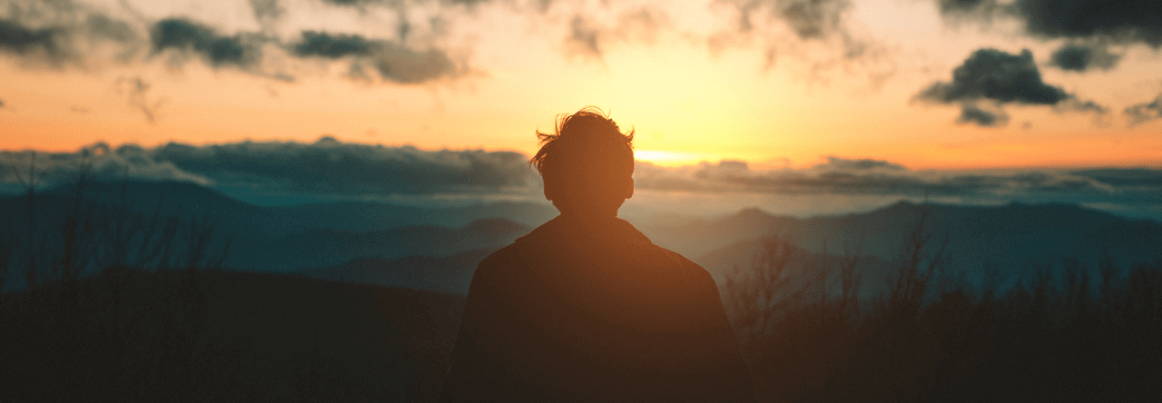 man looking at sunset