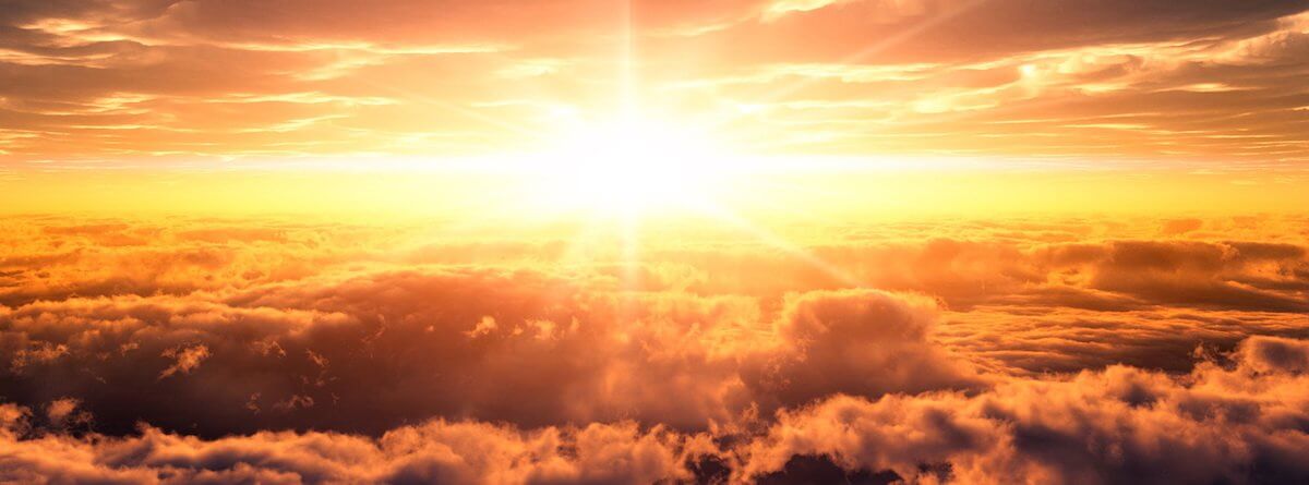 Sun shining over clouds